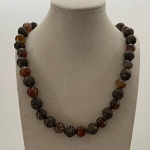 beaded necklace featuring brown agate or carnelian beads and ornate